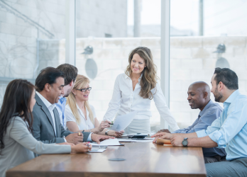 woman presenting at a table of people