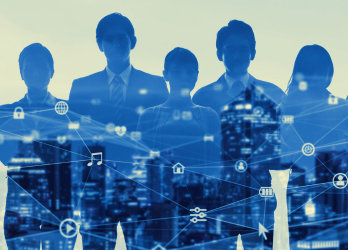 Blue silhouettes of business people over a city skyline with digital network icons