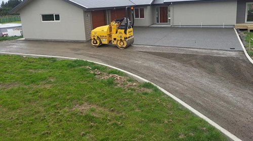 Roller surfacing a road near a home