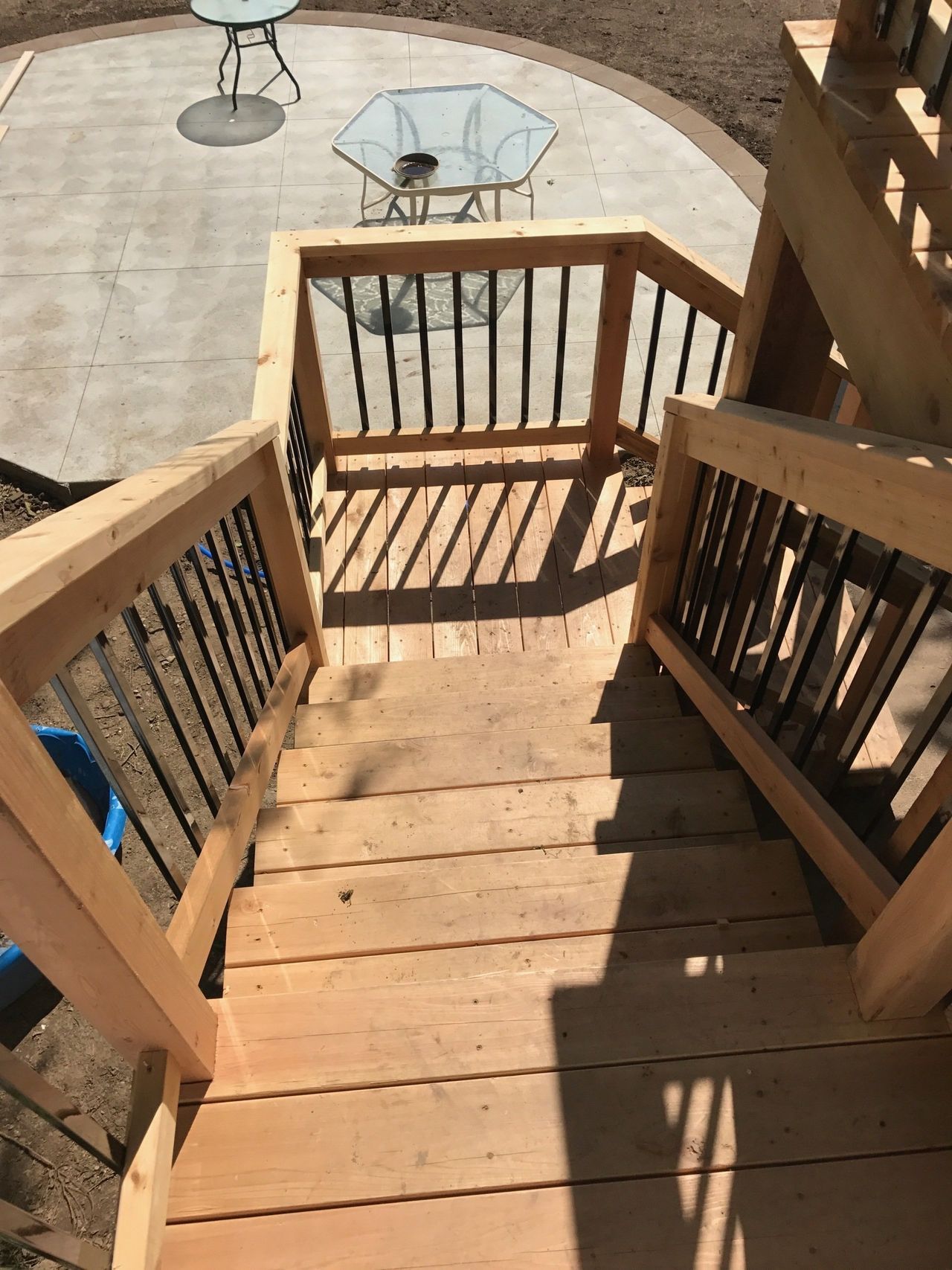 Wooden Stairs Leading Up To A Patio With A Glass Table | Omaha, NE | DRD Home Services