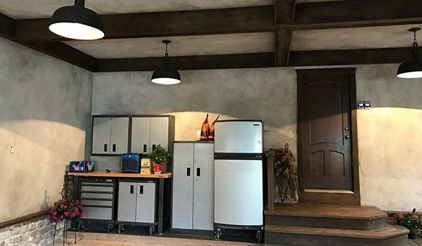 A Garage With A Refrigerator, Cabinets, And A Door | Omaha, NE | DRD Home Services