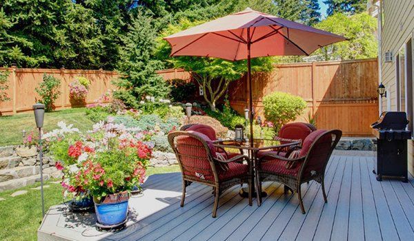 A Patio With A Table And Chairs Under An Umbrella | Omaha, NE | DRD Home Services