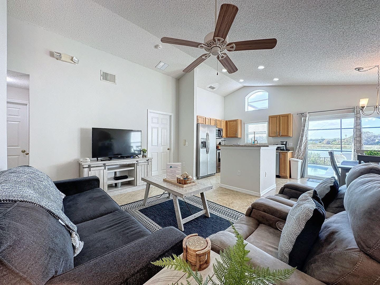 A living room filled with furniture and a ceiling fan.