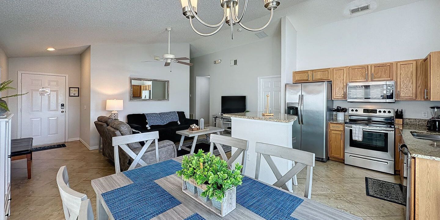 A kitchen and dining room in a house with a table and chairs.
