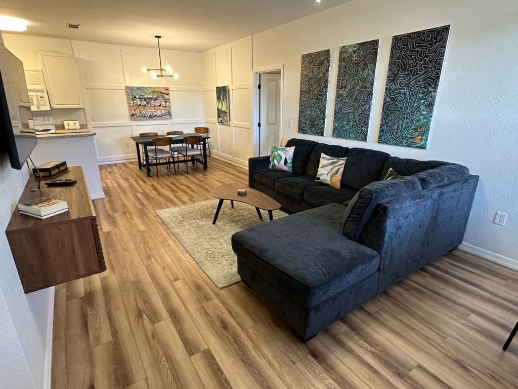 A living room with a couch , table , and television.