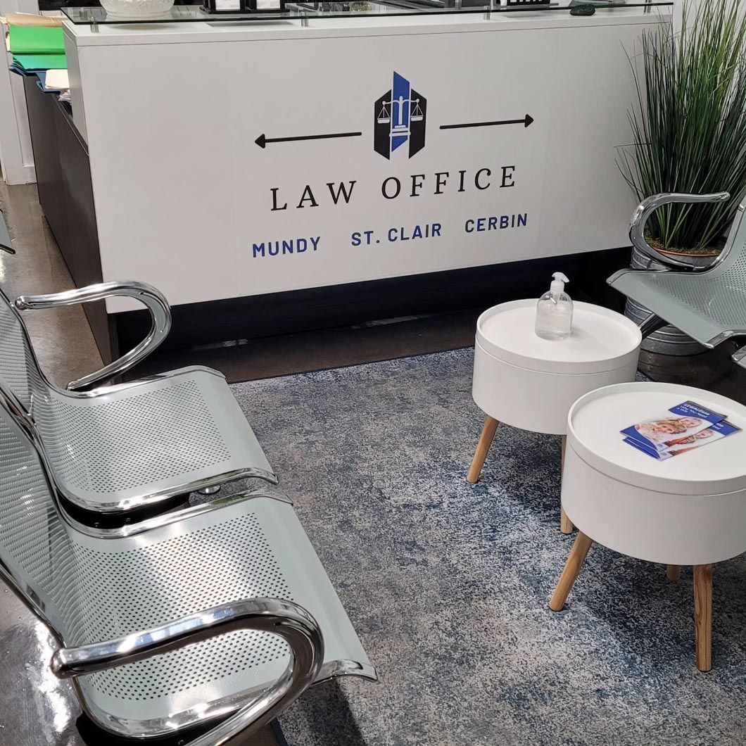A waiting room with chairs and tables in front of a law office.