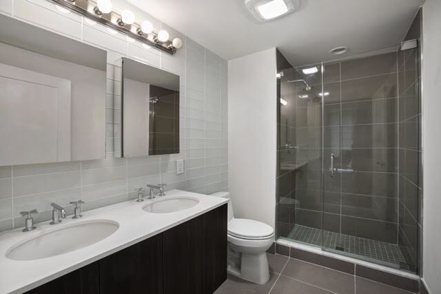 Modern bathroom with gray tiled walls