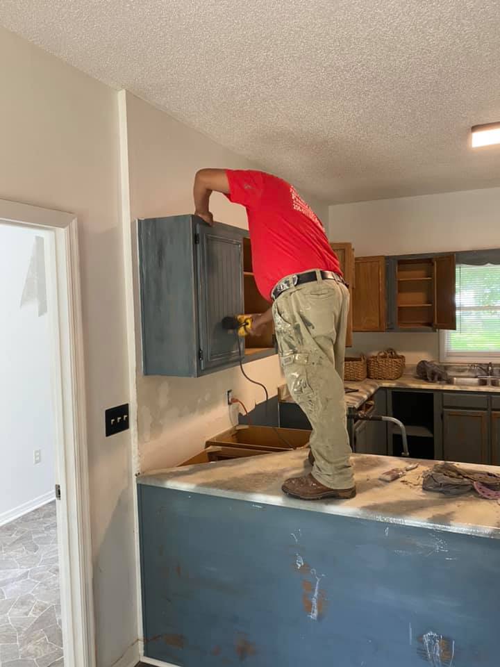 Worker Fixing the Cabinet — Decatur, AL — Sky Painting LLC