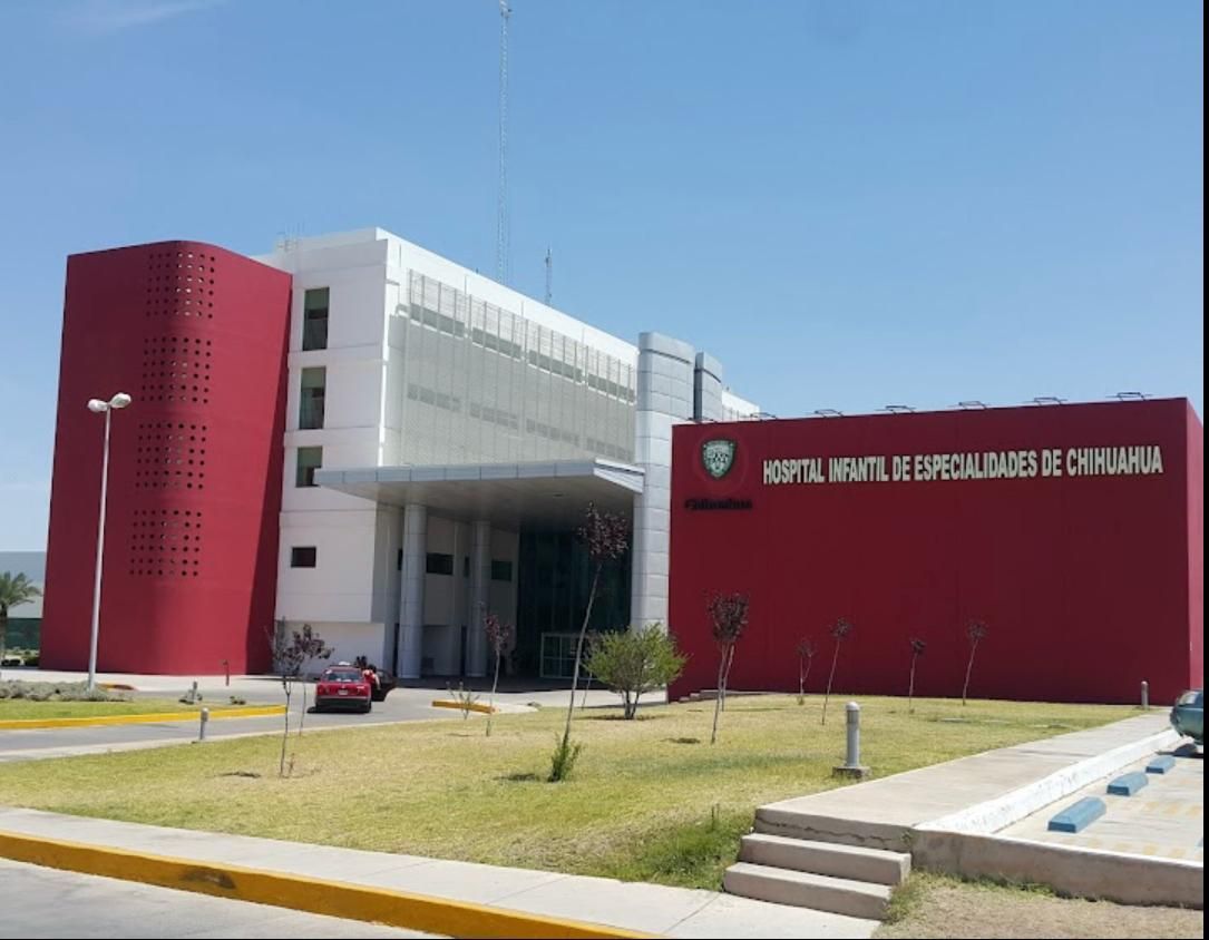 Exterior of Hospital Infantil de Especialidades de Chihuahua, Mexico; red and white building, blue sky.