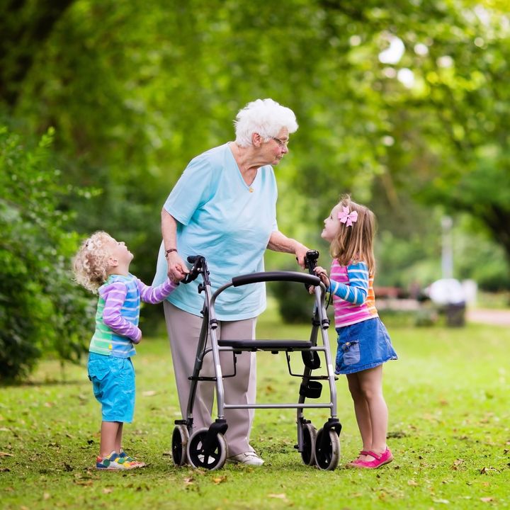 Old woman walking with grandchildren