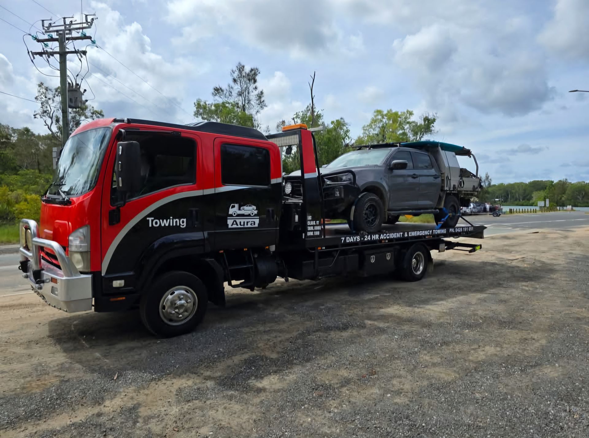 A Red Car is Being Towed by a Tow Truck — Aura Towing Service in Baringa, QLD