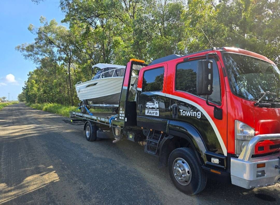 A Red Car is Being Towed by a Tow Truck — Aura Towing Service in Baringa, QLD