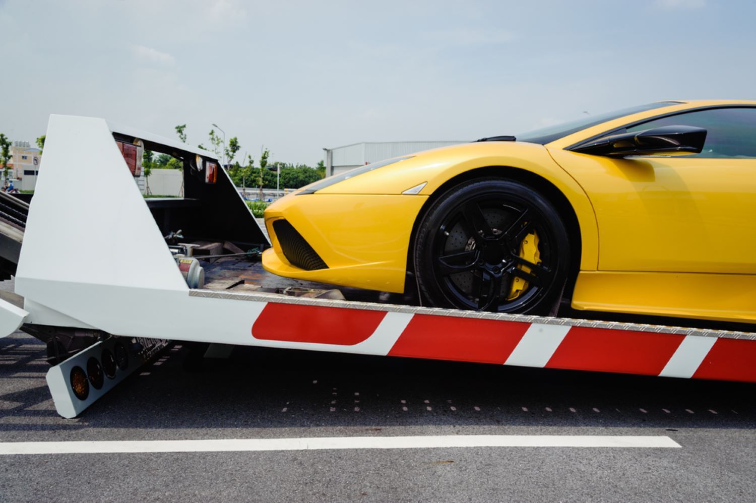 A Yellow Sports Car is Being Towed by a Tow Truck — Aura Towing Service in Noosa, QLD