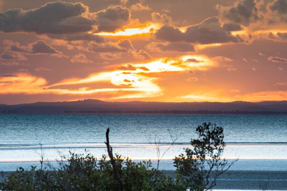 Sunset Over a Calm Body of Water — Aura Towing Service in Bells Creek, QLD