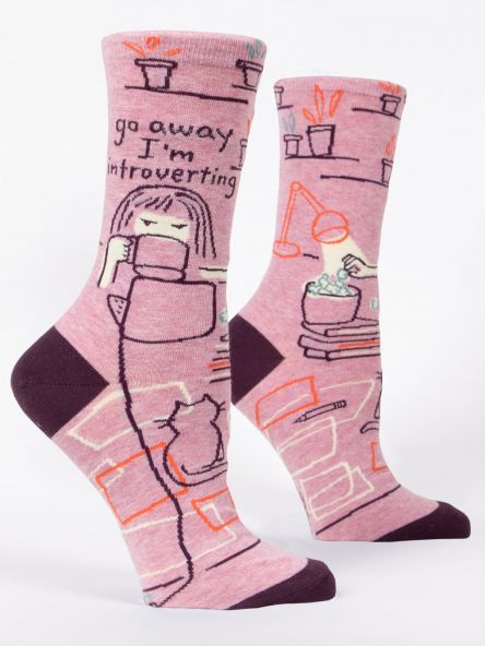 A pair of pink socks that say go away i 'm introverting
