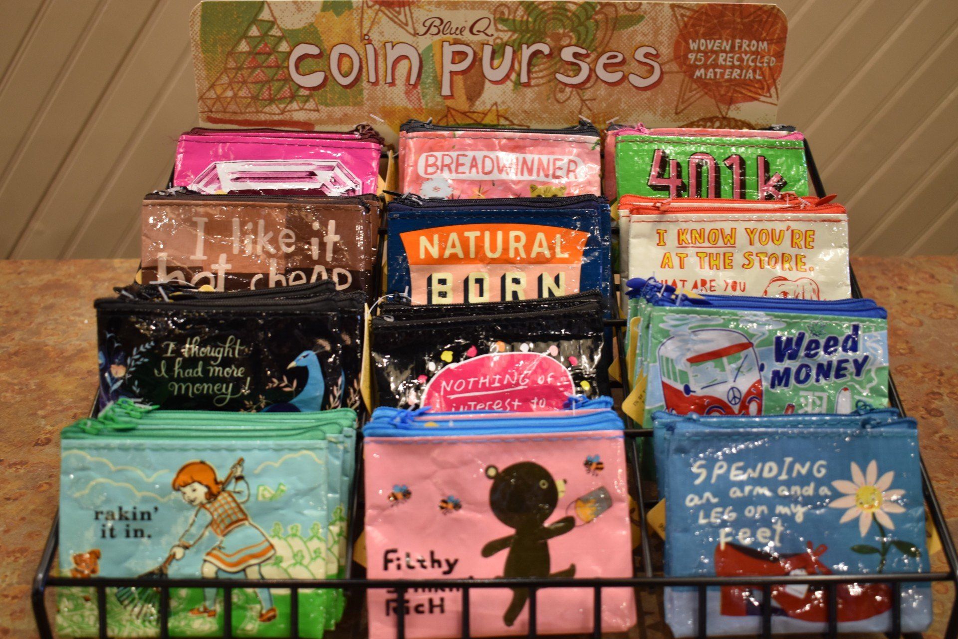 A display of coin purses with one that says natural born