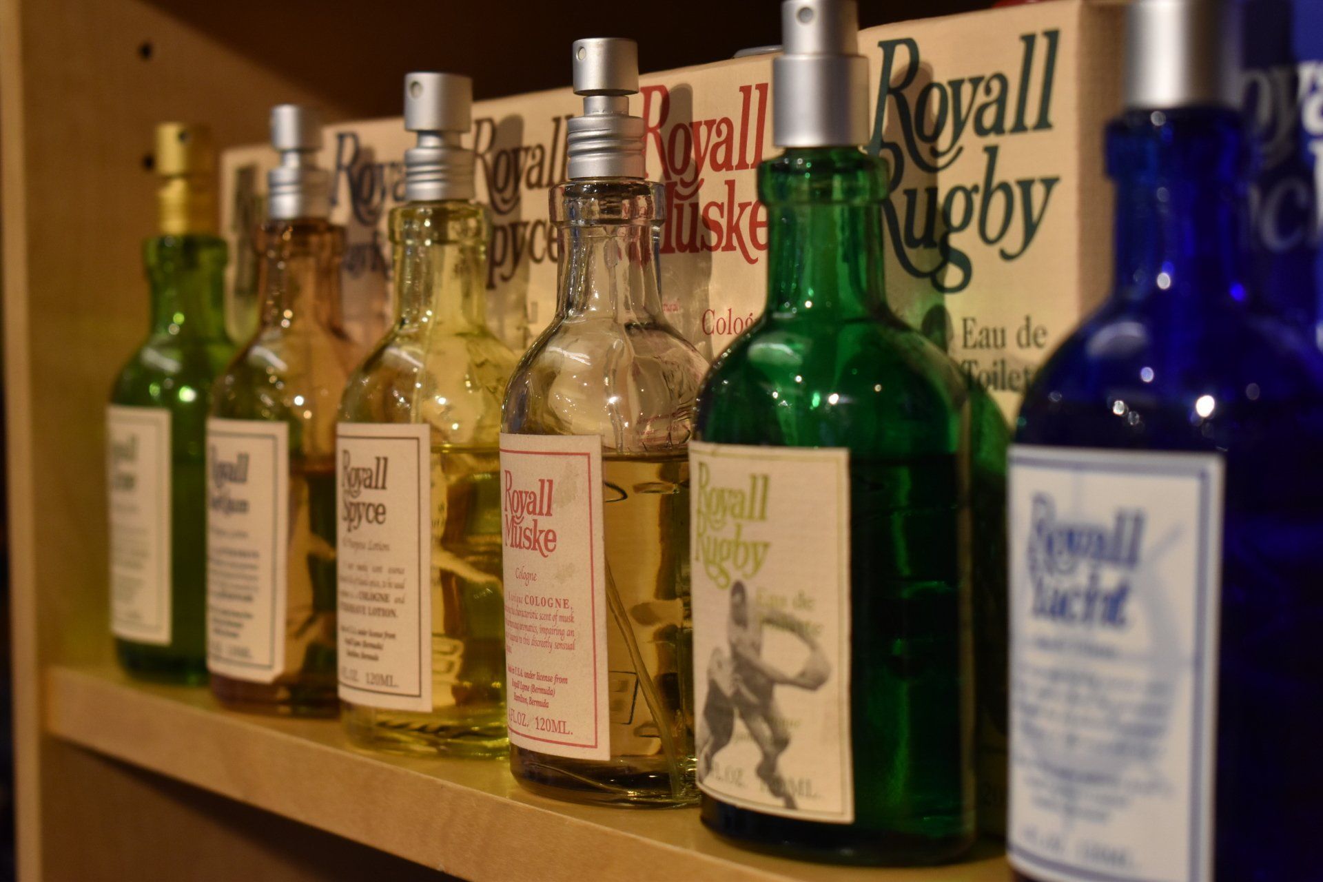 A row of bottles of royal rugby cologne on a shelf