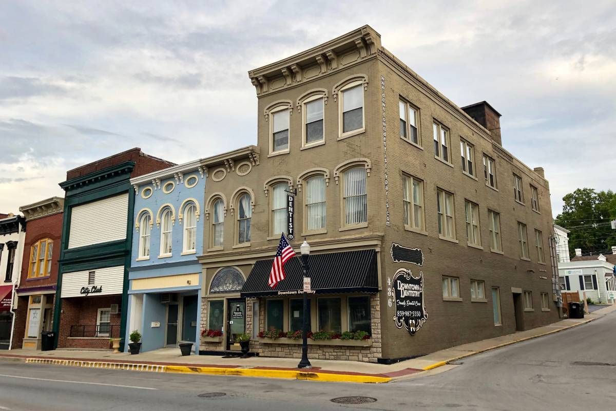 A row of businesses on Main Street in Paris, KY, during a cloudy day