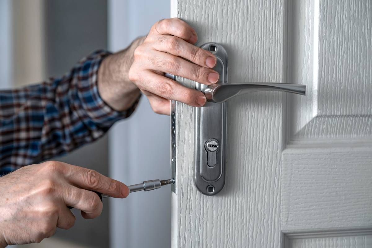 An residential locksmith opening an apartment door near Lexington, Kentucky (KY)