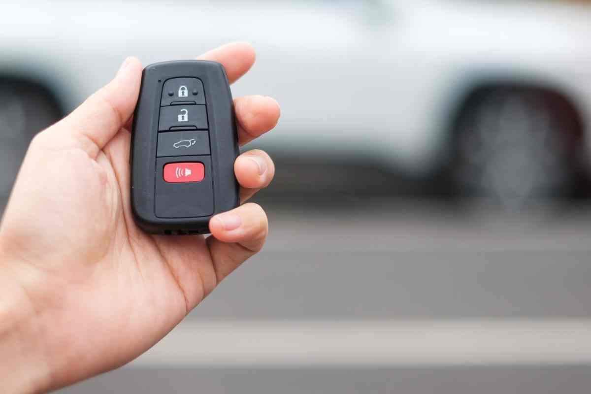 Person's hand holding a key fob outside a vehicle at King's Locksmiths near Lexington, KY