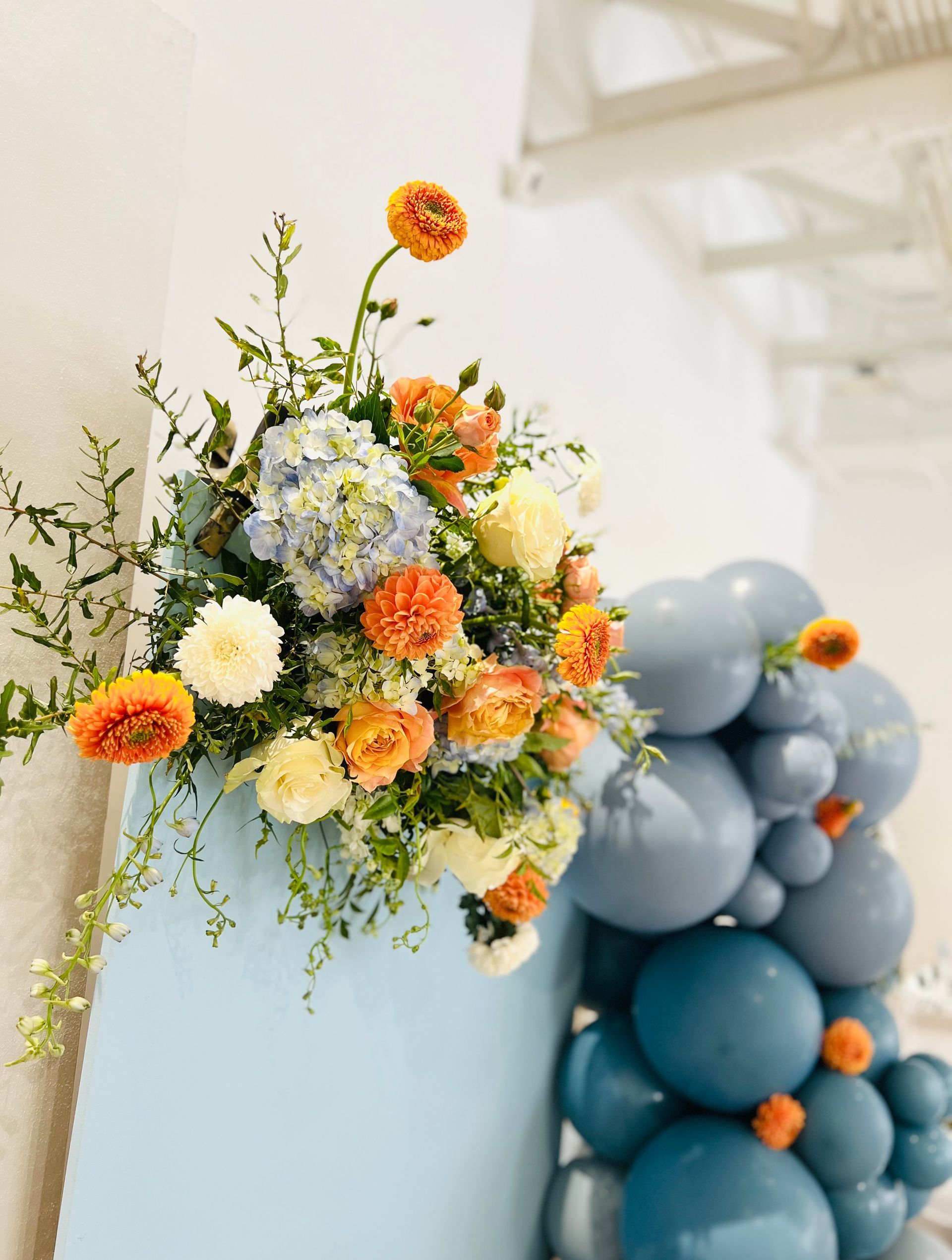 Blue and orange first birthday theme with flowers and balloons