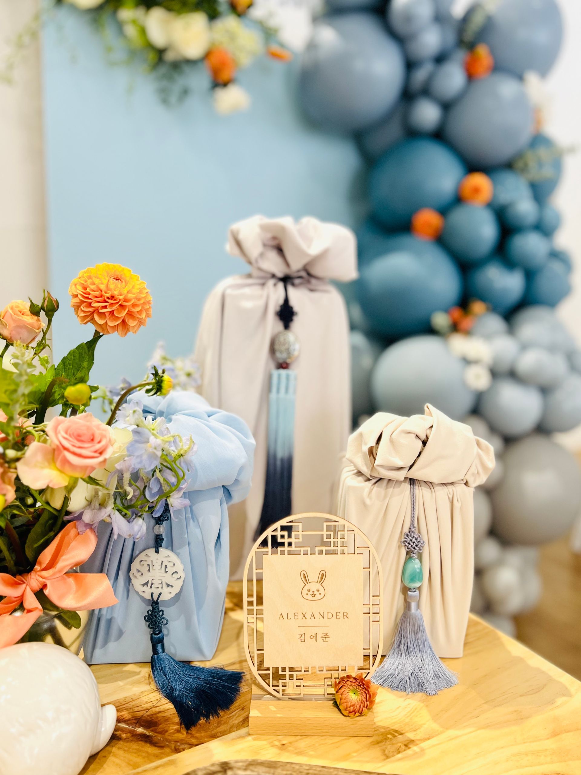 Blue and orange first birthday theme with flowers and balloons