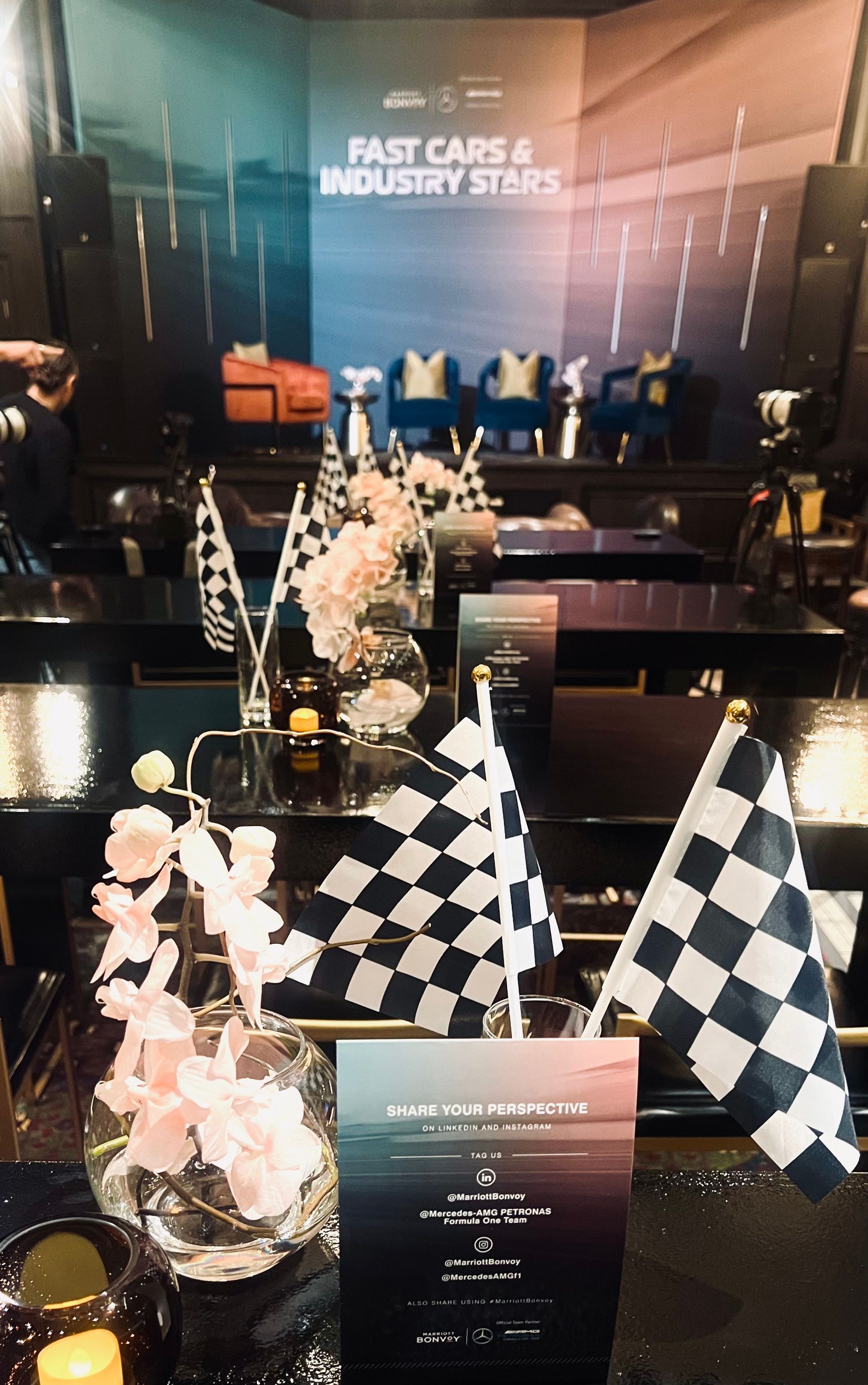 A table with flowers and candles in front of a welcome sign