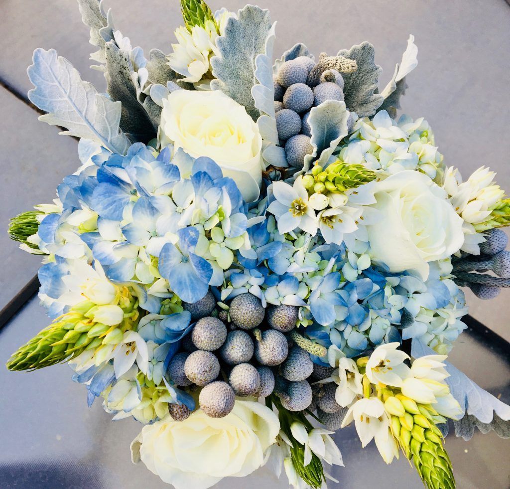 A bouquet of blue and white flowers on a table