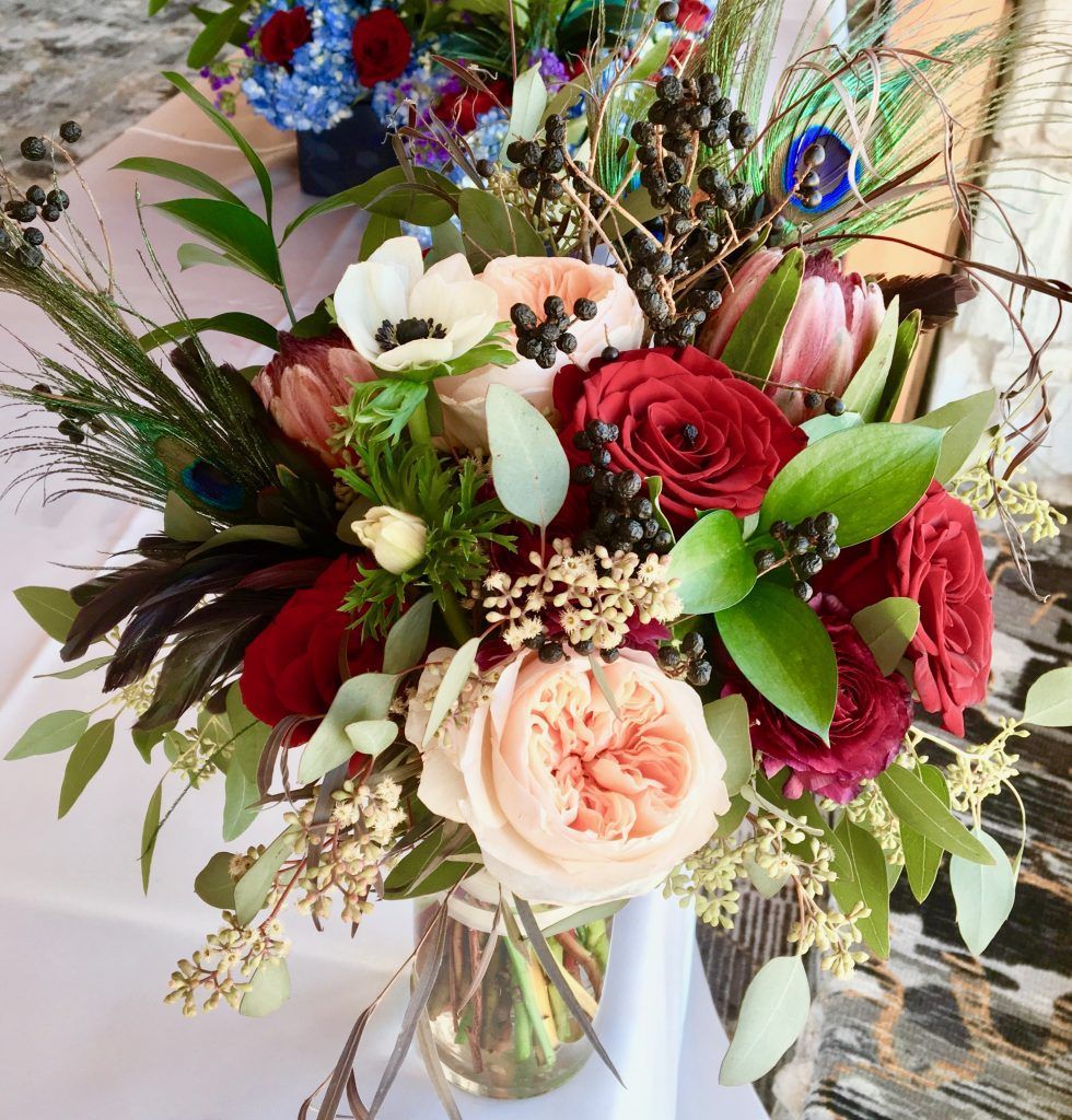 A bouquet of flowers in a vase on a table.