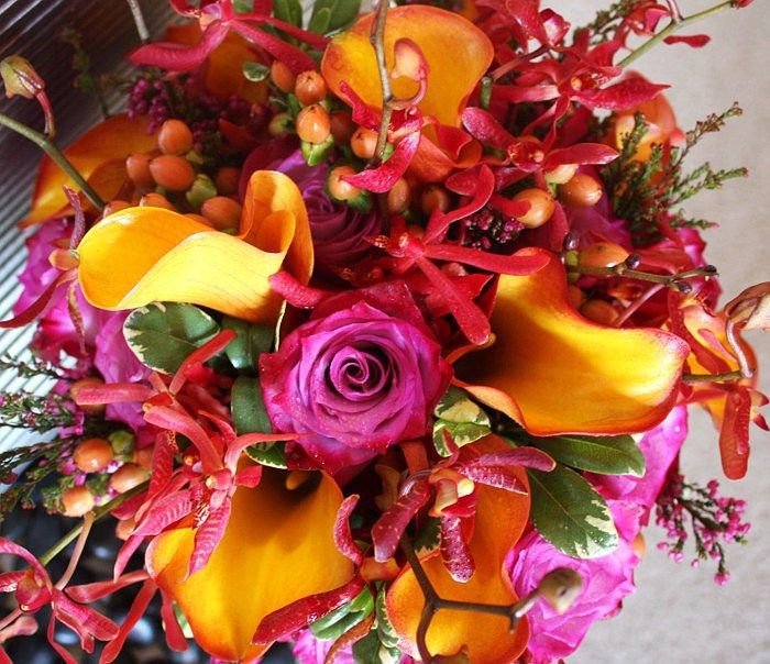 A bouquet of flowers with a pink rose in the middle