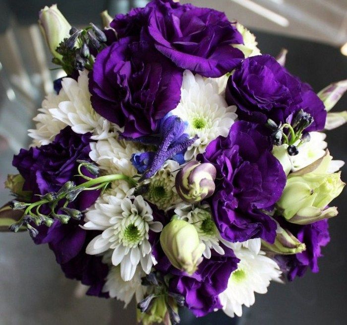 A bouquet of purple and white flowers on a table