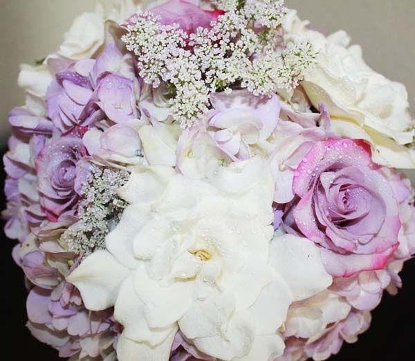 A bouquet of purple roses and white flowers