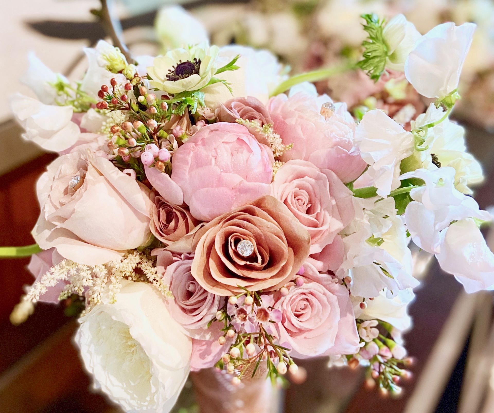 A close up of a bouquet of pink and white flowers on a table.
