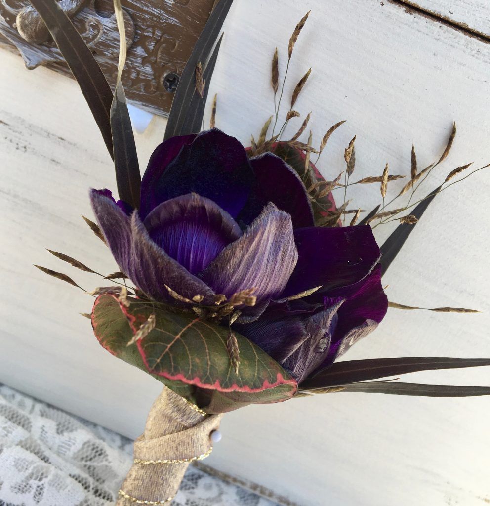 A close up of a purple flower on a table