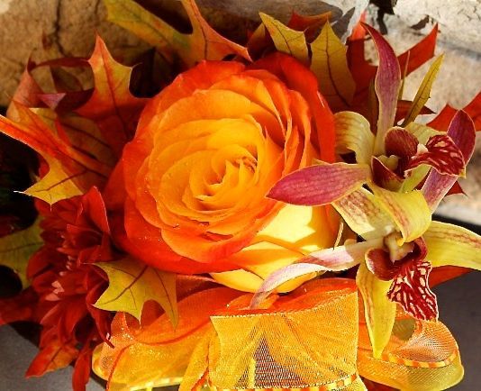 A bouquet of orange and yellow flowers and leaves