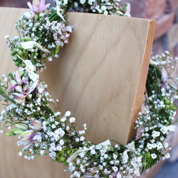 A wreath of flowers is sitting on a wooden board