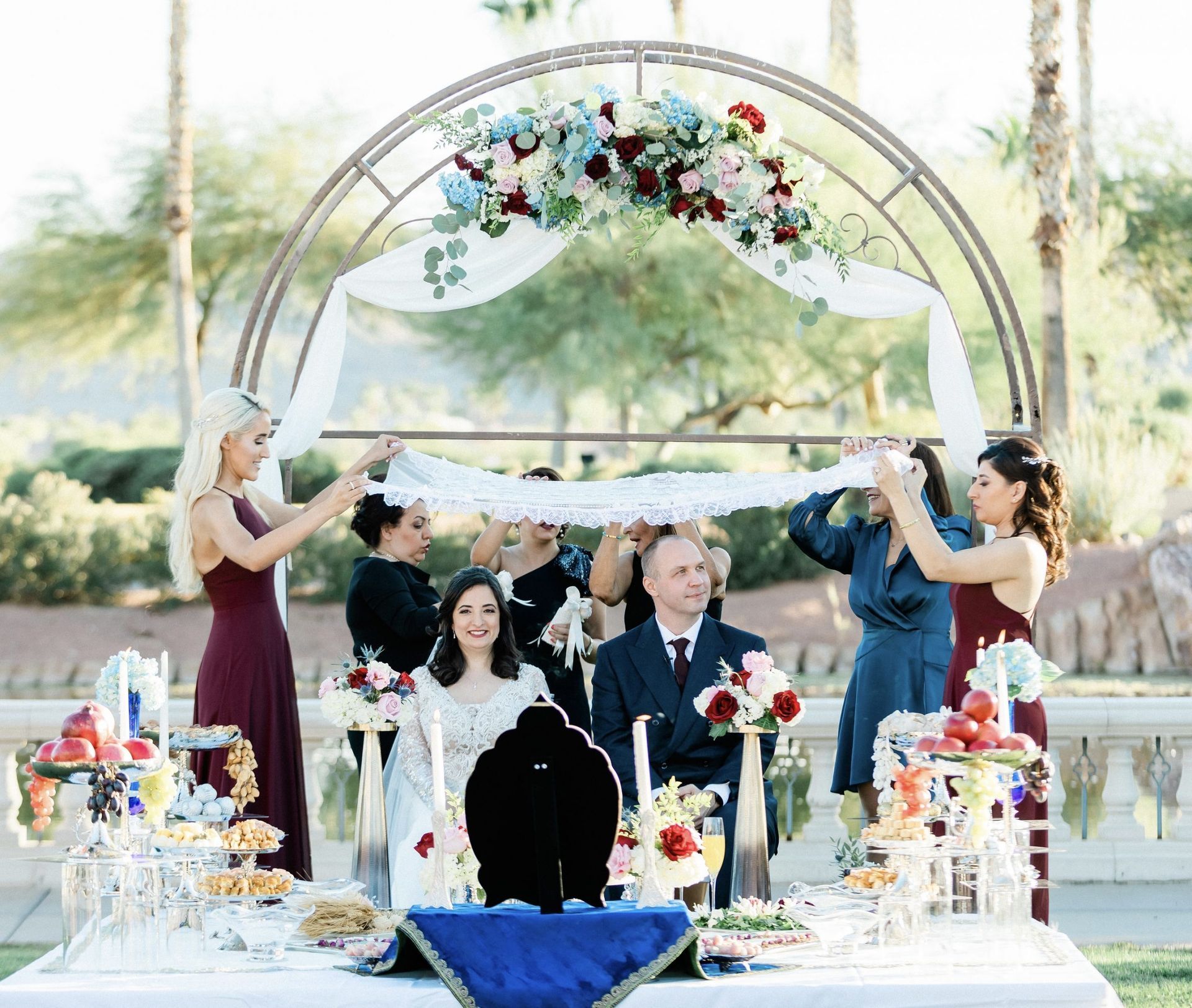 A group of people are standing around a table at a wedding.