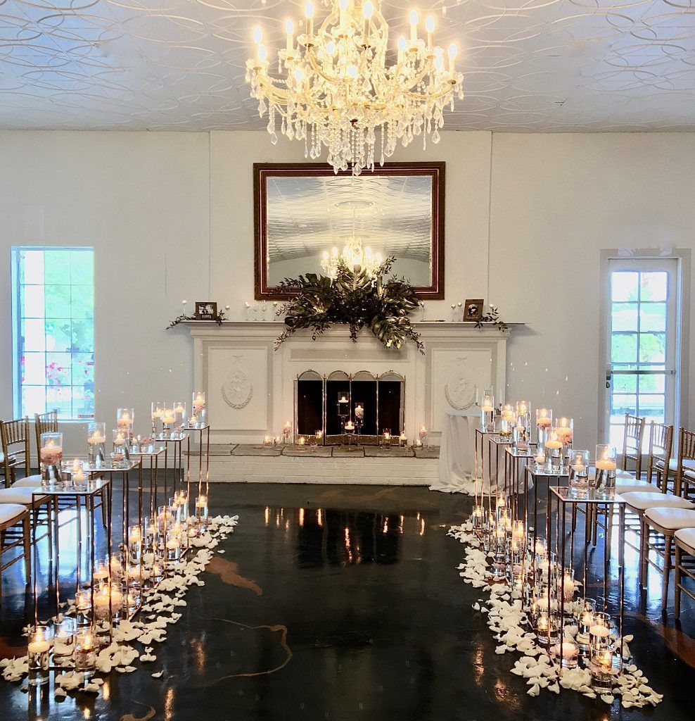 A room with a fireplace and candles on the floor