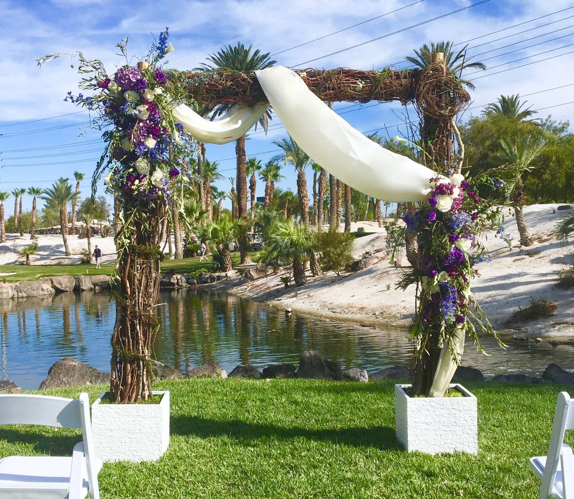 A wedding arch decorated with purple and white flowers