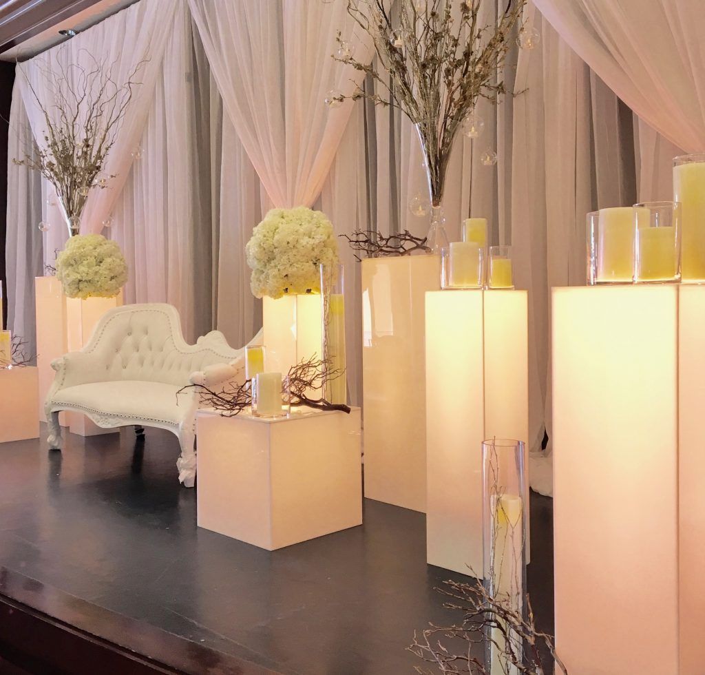 A stage with a couch and candles on it