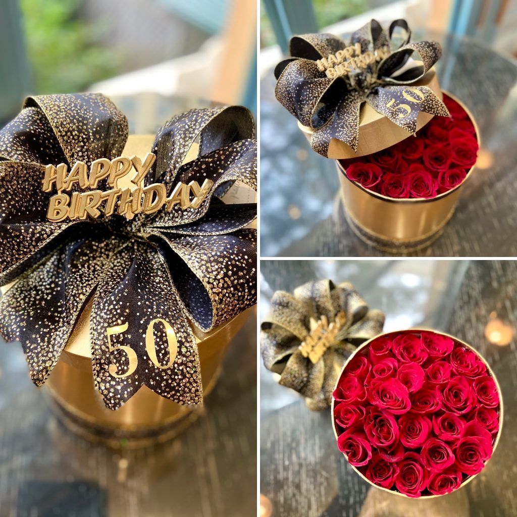 A box of roses with a bow and the number 50 on it