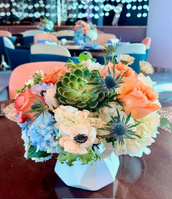 A vase filled with flowers is sitting on a table.