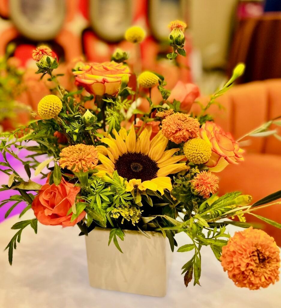 A vase filled with flowers is sitting on a table.