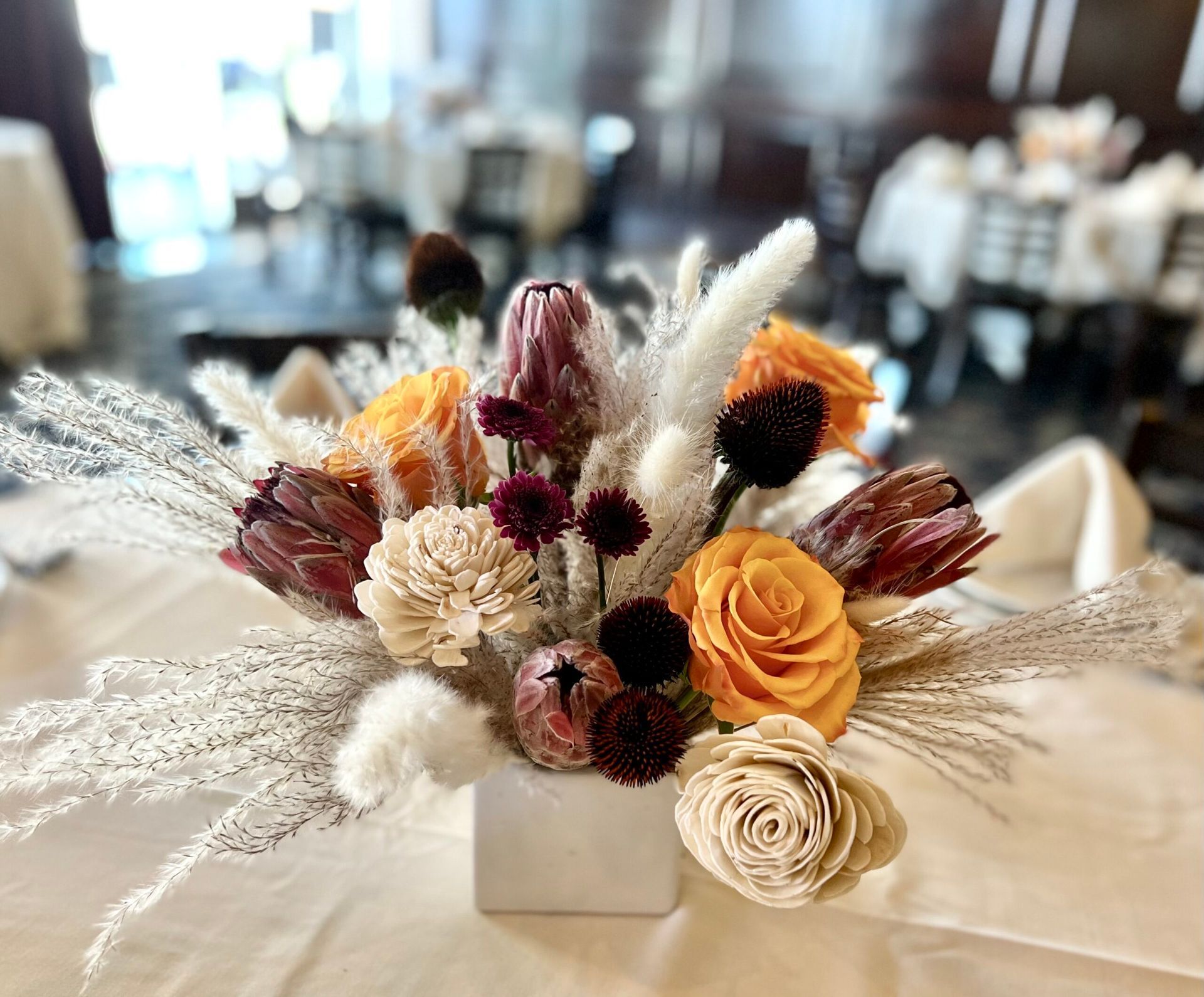 A vase filled with flowers is sitting on a table.