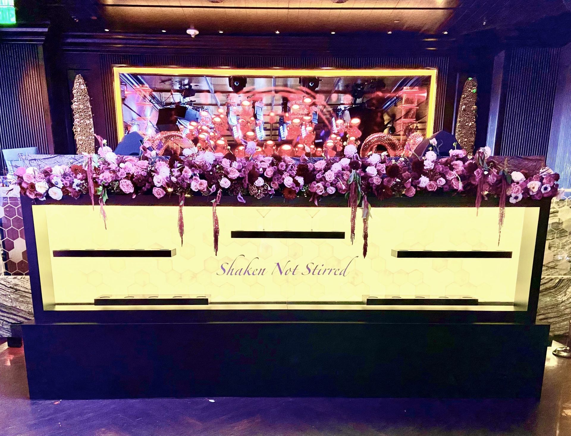 A large display case with purple flowers on top of it.