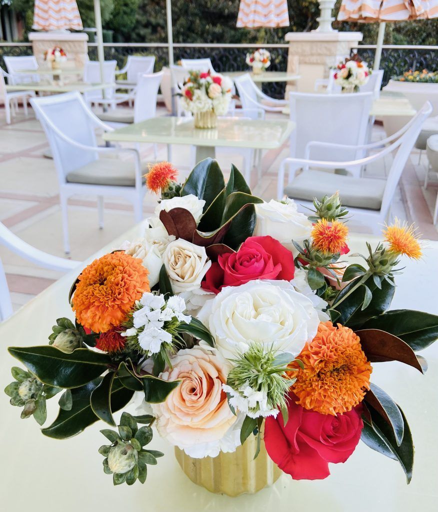 A table with a vase of flowers on it