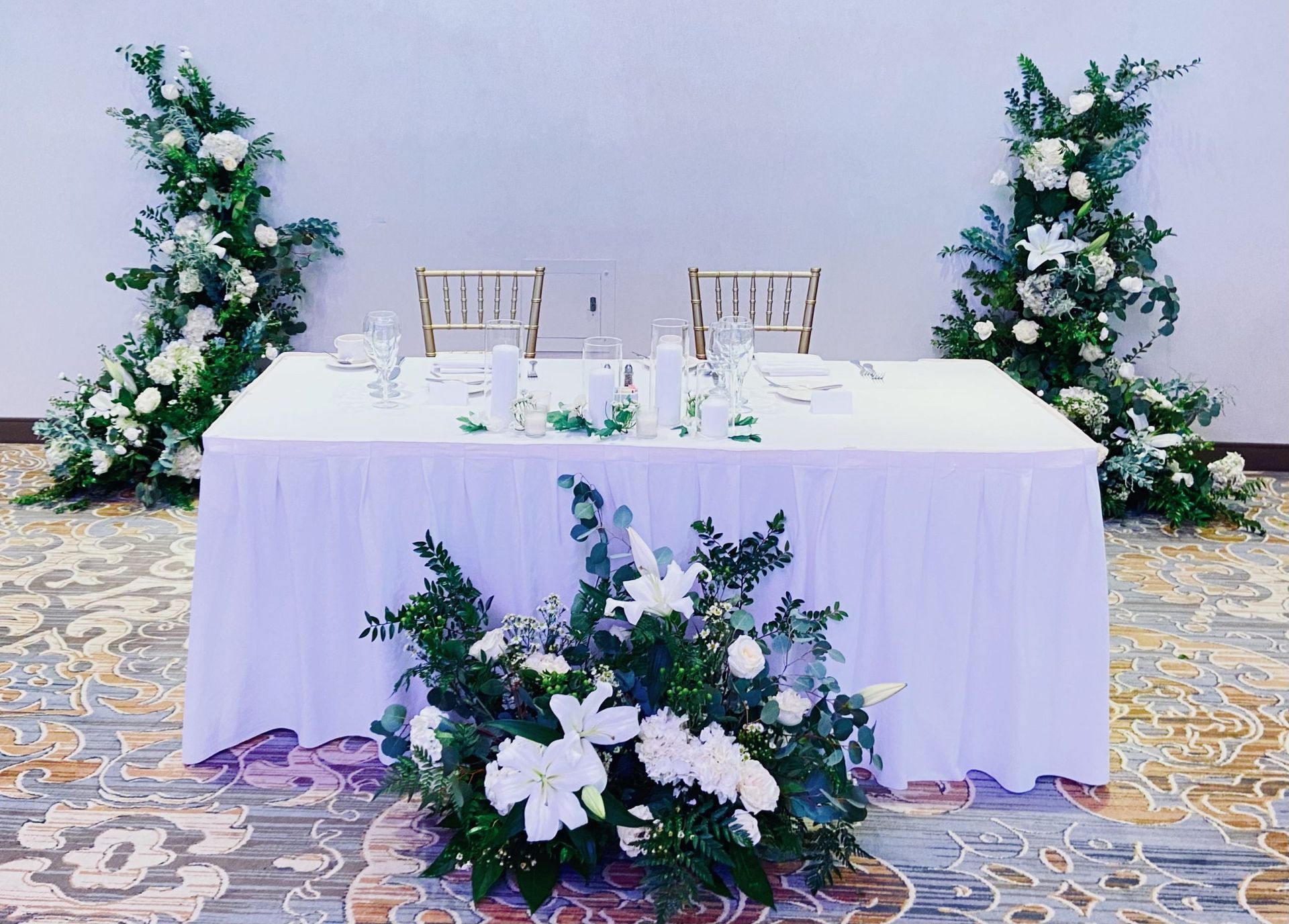 A table with a white tablecloth and flowers on it.