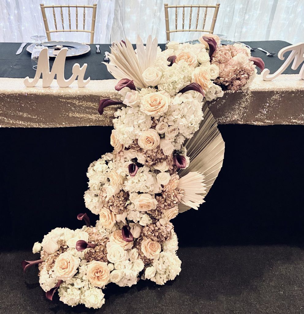 A table with flowers and a sign that says mr. and mrs.