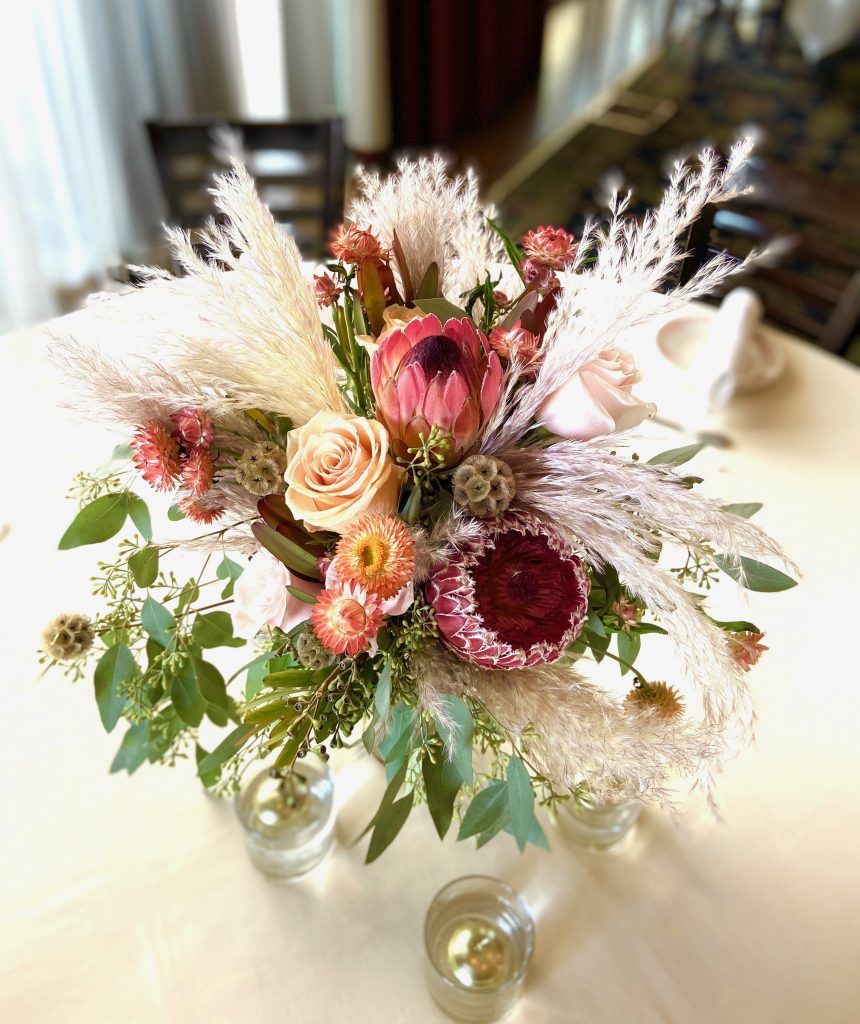 A vase filled with flowers is sitting on a table.