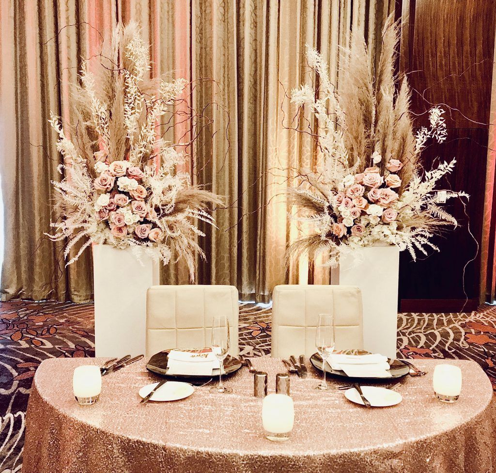 A table with plates , candles , and flowers on it.